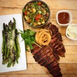 Kingston Massachusetts restaurant Solstice steak and asparagus dinner served on a wooden board
