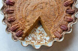 Nutiva's gluten-free pie crust is darker in color and here is stuffed with pumpkin pie filling and topped with pecans