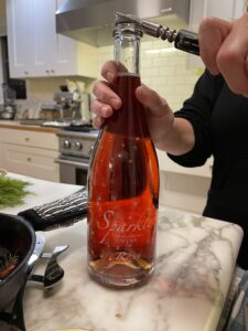 Sparklet Sparkling Rose Wine from Sauvage Spectrum Winery being opened in my friend's kitchen