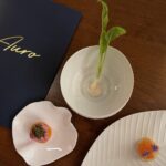 Auro restaurant menu with three plates of amuse bouche