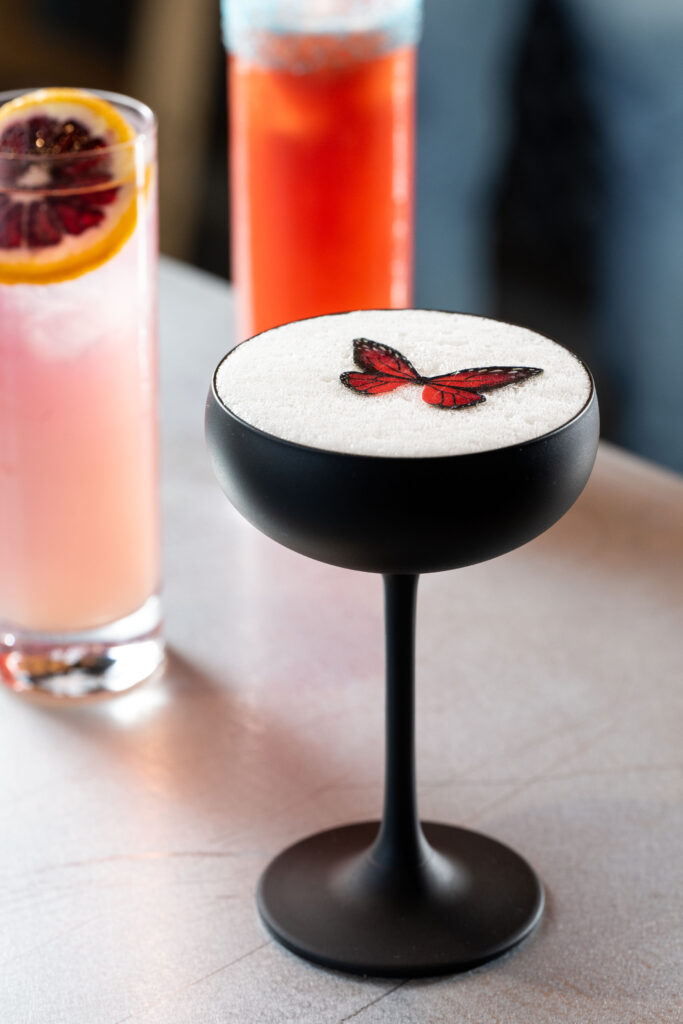 a new cocktail at La Mar Bar, topped with an edible butterfly