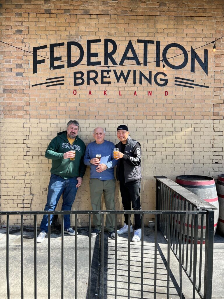 Aram Cretan, co-founder and head brewer at Federation; Larry Cretan, co-founder and CFO at Federation; Youngwon Lee, founder and CEO of Dokkaebier in front of the Feederation taproom