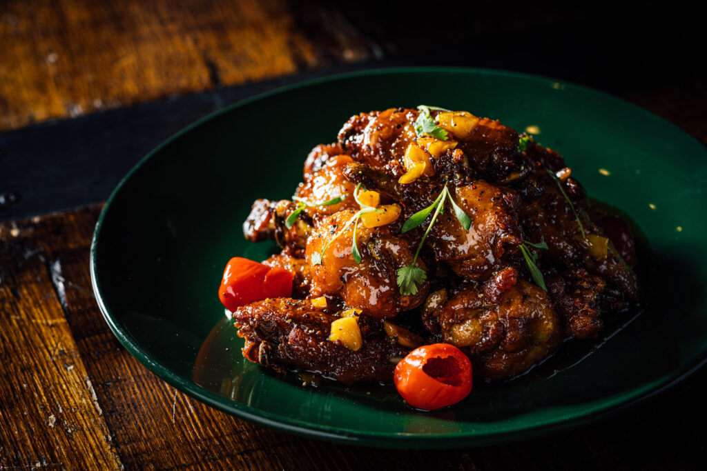 pollo guisado wings at alaMar Dominican Kitchen, photo credit: Eric Wolfinger