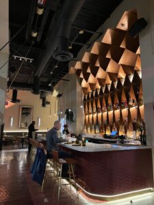 interior bar with lighted honeycomb cubbies at Pippal restaurant in Emeryville