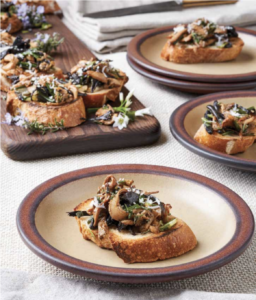 foraged mushroom and leek toast on a brown plate with brown edge