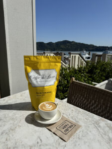 latte and a bag of Caffe Luxxe coffee on the patio at Tiburon's Malibu Farm restaurant