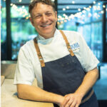 Chef Michael Siegel of Mill Valley's Corner Bar restaurant in chef whites and a blue apron