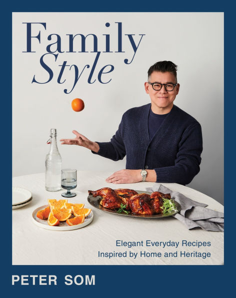 designer Peter Som throwing an apple in the air in front of a table laden with food