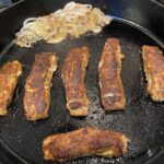 blackened halibut and onions in the pan