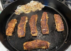 blackened halibut and onions in the pan