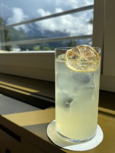 Chamomile tonic in front of the window at Bergwald Bar in Wengen