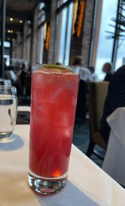 Dos Flores tonic cocktail in front of the huge windows at Waterbar restaurant