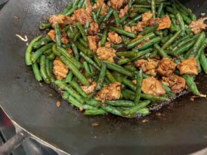 green bean and stir fry chicken in the wok