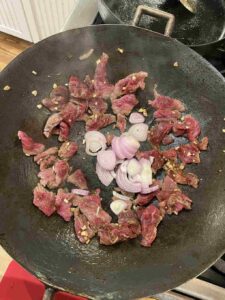 The recipe for Kampot noodles with coconut fish sauce dressing calls for stir-frying beef