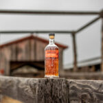 Pendleton 1910 Whisky set on a worn out wooden fence in front of a barn