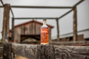 Pendleton 1910 Whisky set on a worn out wooden fence in front of a barn