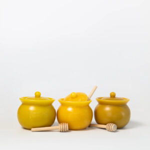 Sonoma County Bee Co mini beeswax honeypot and stirrer. Each is a slightly different shade of yellow.