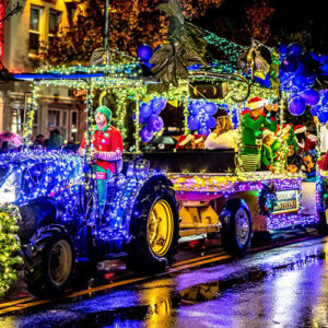 a tractor covered in colored lights in Calistoga for the tractor parade