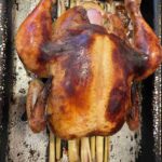 coca-cola chicken rests on a bed of lemongrass, infusing the meat with delicious flavor