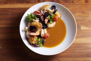 a dish of crispy rice with shrimp and calamari at Bauble Bar at Four Seasons San Francisco - resized