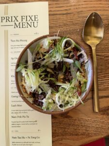 Rice Salad next to a spoon and the tasting menuat Tanzie's Thai restaurant in Berkeley