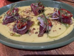 ahi crudo pieces atop vanilla-scented vinagrette