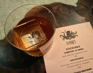 You can see right through the ice cube to the graphic drawing of a long-haired woman in this Nightshade Nightmore cocktail from Shinji's at True Laurel