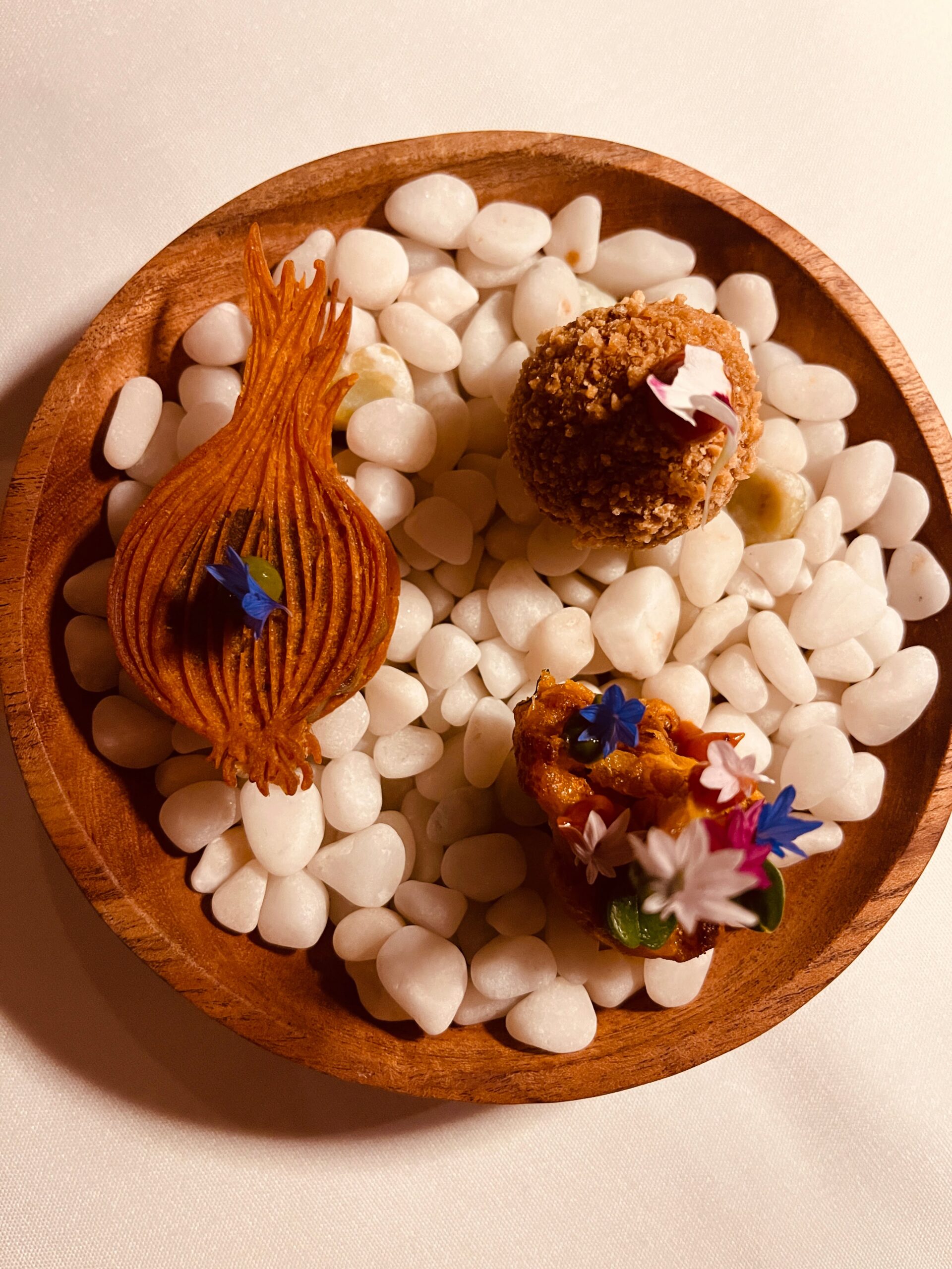 cute canapes on top of white rocks in a bowl