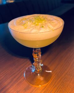 an ocean view cocktail with a creamy, foamy top that makes the "salt air" in a coupe at BOA Steakhouse