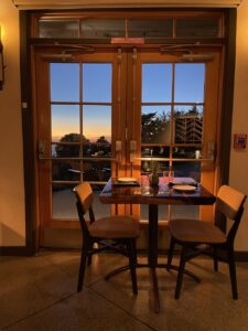 dinner table in The Lodge with a view of the sunset at Treebones Big Sur