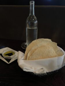 gluten-free bread (papadums), water and olive oil on a black background at La Toque in Napa