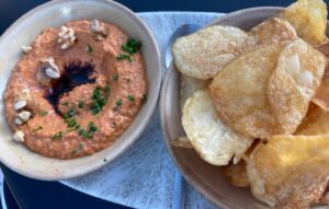 gluten-free muhammara and a bowl of potato chips at Rise Over Run rooftop restaurant in San Francisco