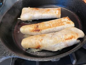 Crab Burritos browned up nicely in a cast iron pan