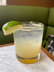 Kick Back cocktail with a lime wedge on the glass at Maggie & Mac's restaurant San Francisco Inner Sunset