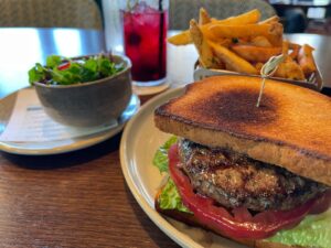 lunch at Matchplay restaurant at Silverado Resort Napa – burger on GF bun, green slaw, fries, and cassis sparkler