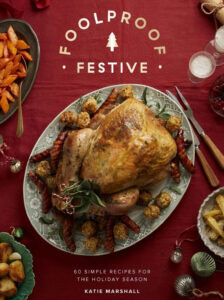 cover image of Foolproof Festive by Katie Marshall is a turkey on a patterned platter surrounded by side dishes and festive drinks